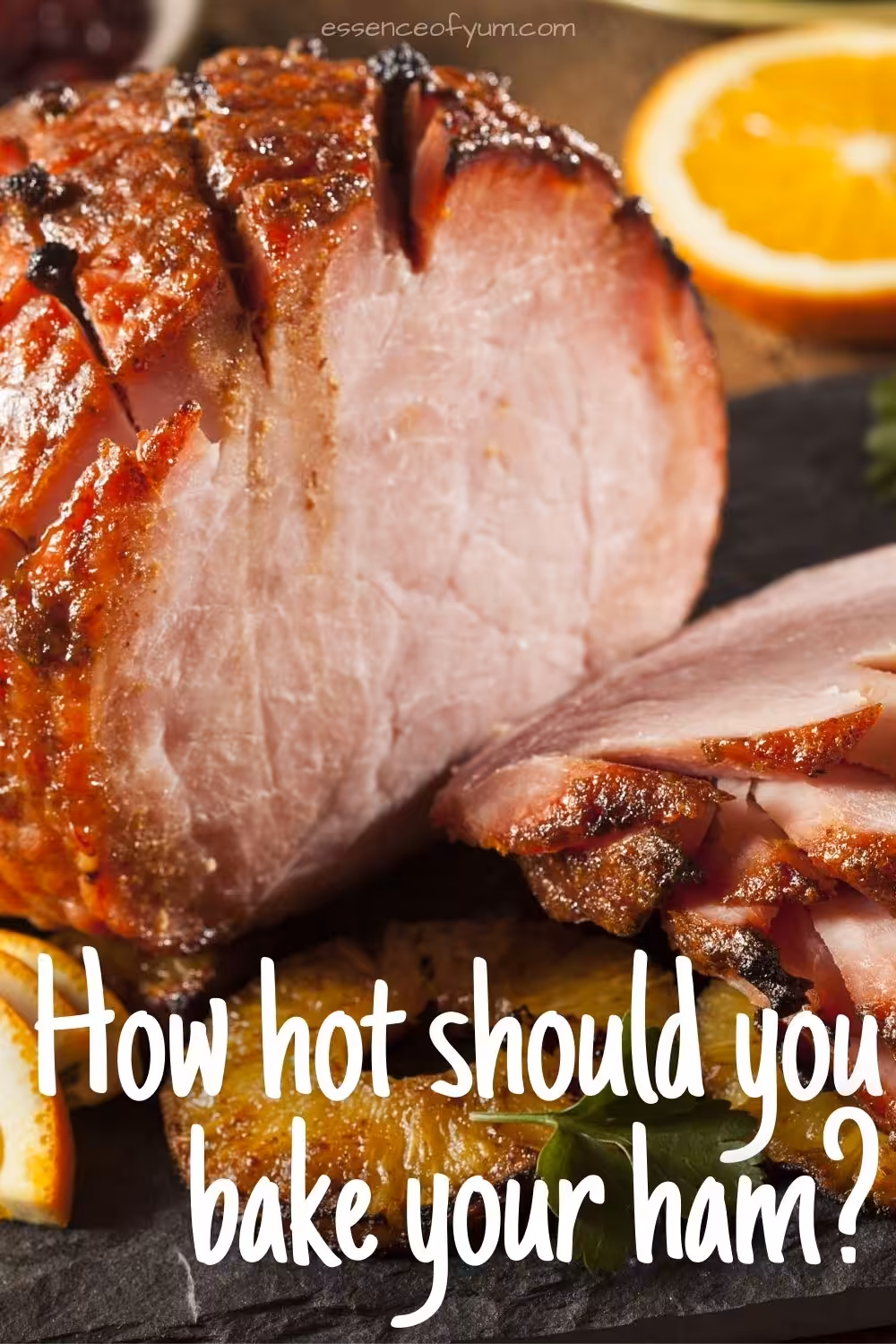 Closeup of a boneless baked ham with the text how hot should you bake your ham.