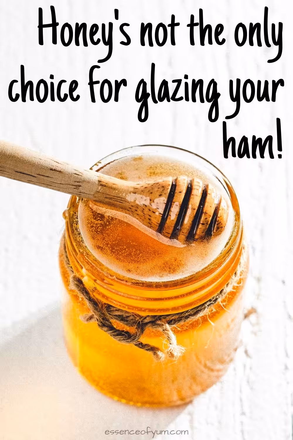 A jar of honey with a honey spoon and the text honey's not the only choice for glazing your ham.
