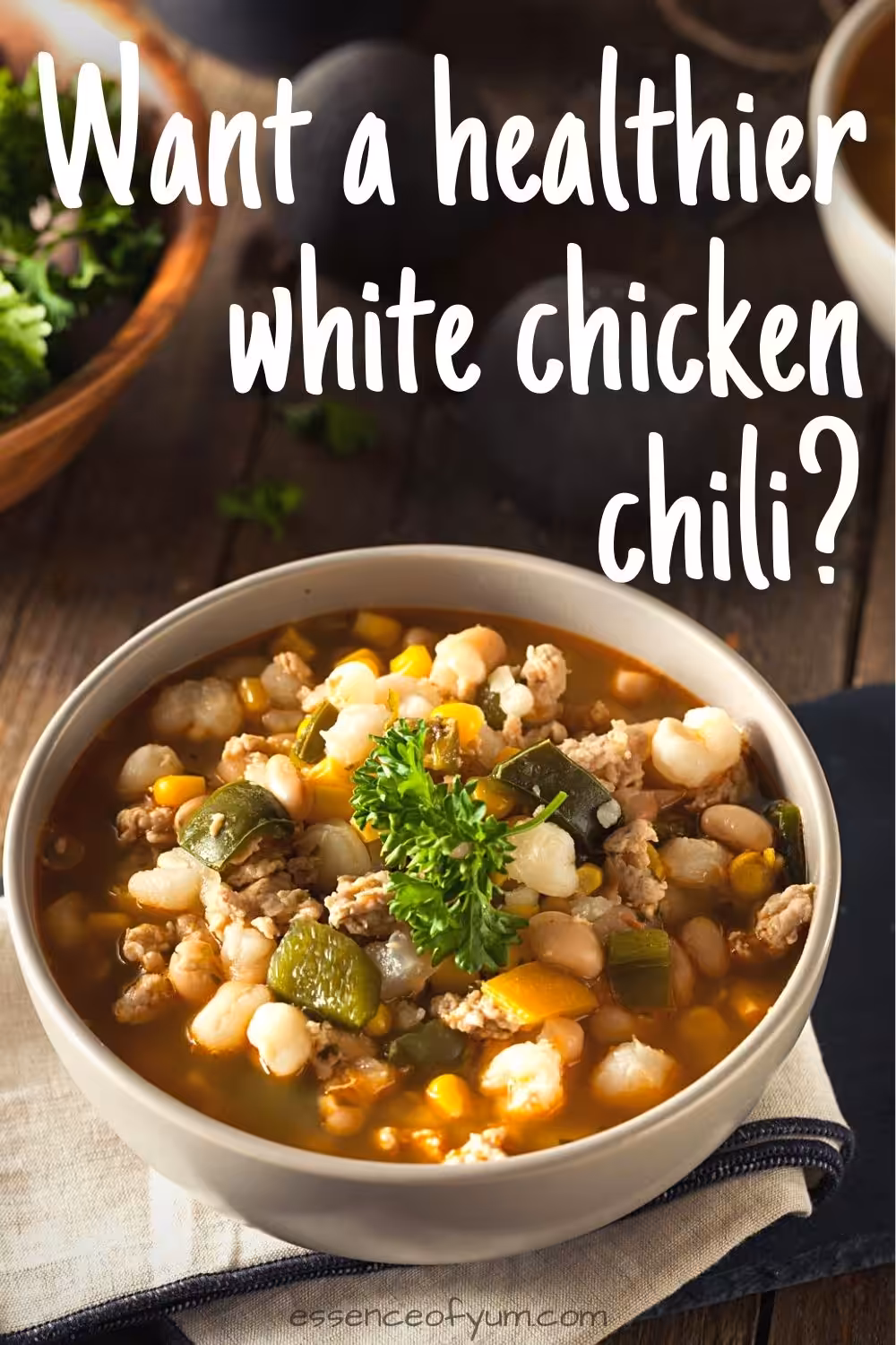 A bowl of white bean chicken chili with corns, peppers and hominy, plus the text want a healthier white chicken chili.