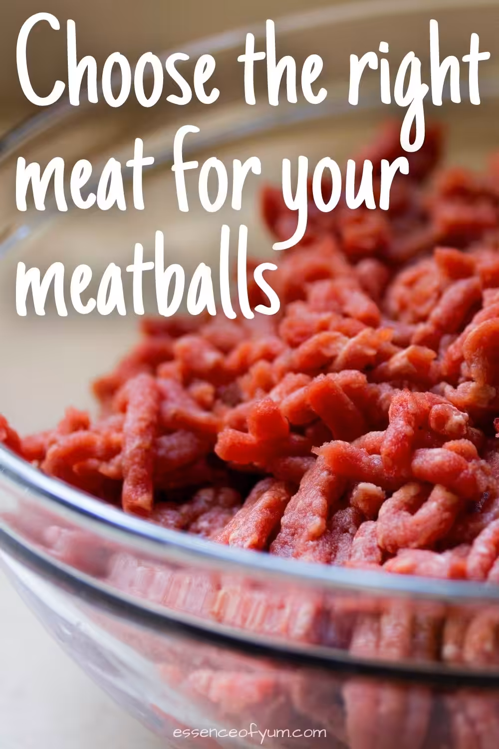 Closeup of a glass bowl full of ground red meat with the text choose the right meat for your meatballs.
